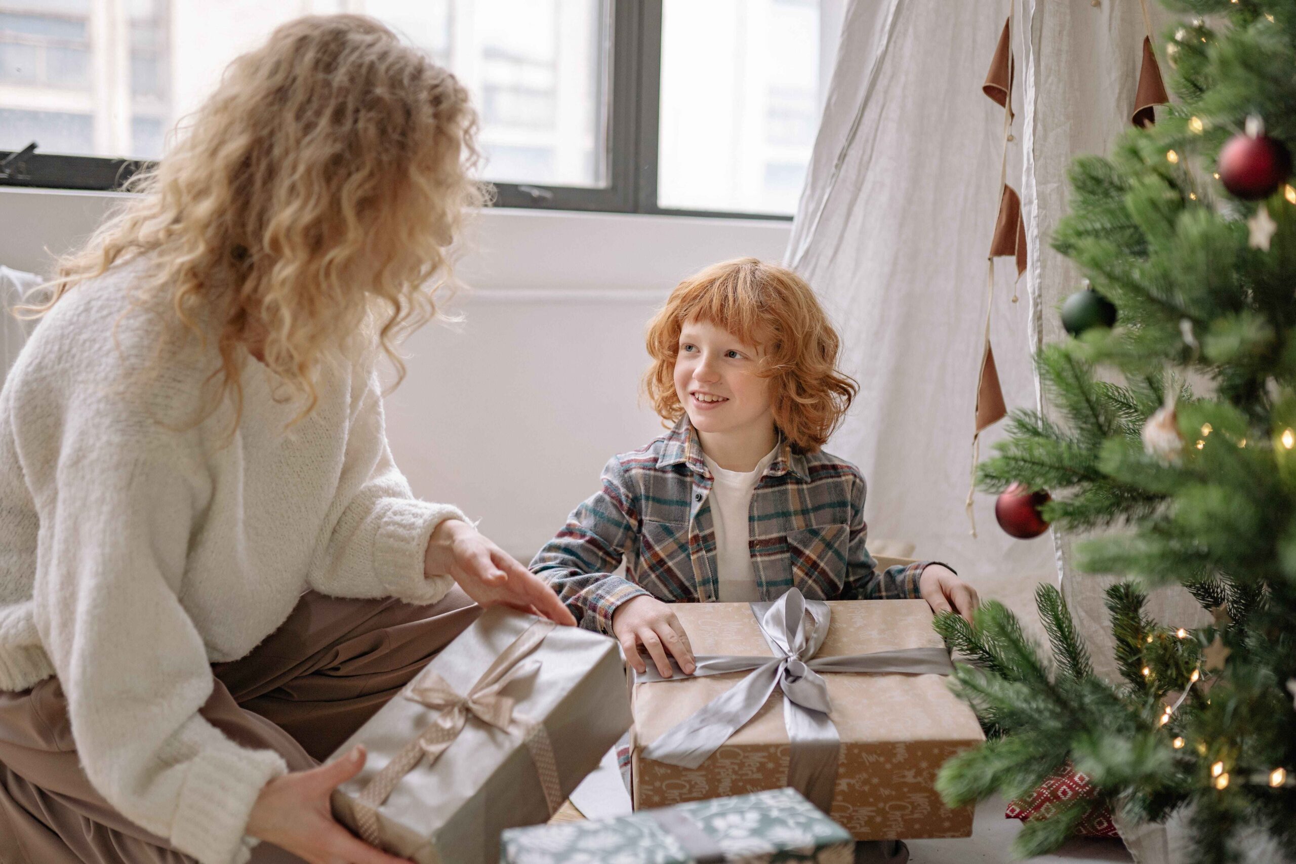 Child and mother opening Christmas presents